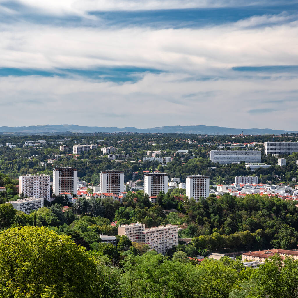 Aerial view of the suburbs of Lyon French city with some skyscrapers and apartments in middle of nature